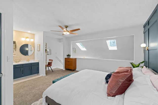 a bed room with a bed and a chandelier