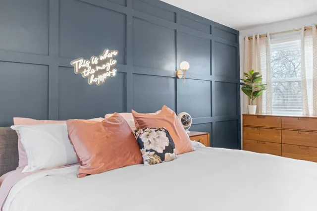 a bedroom with a bed and a chandelier