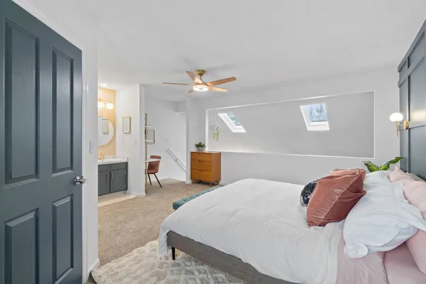 a bedroom with a bed and a chandelier