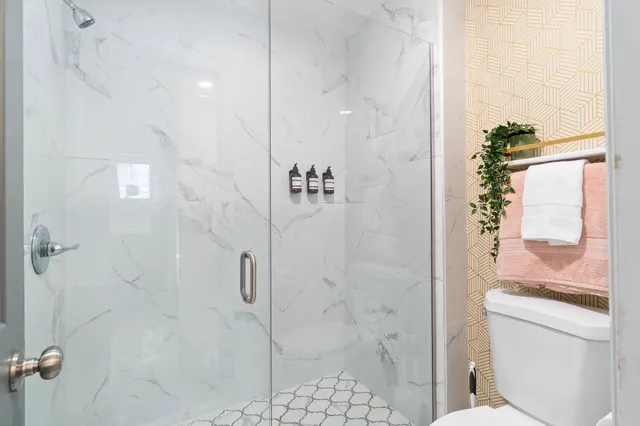 a bathroom with a shower and toilet