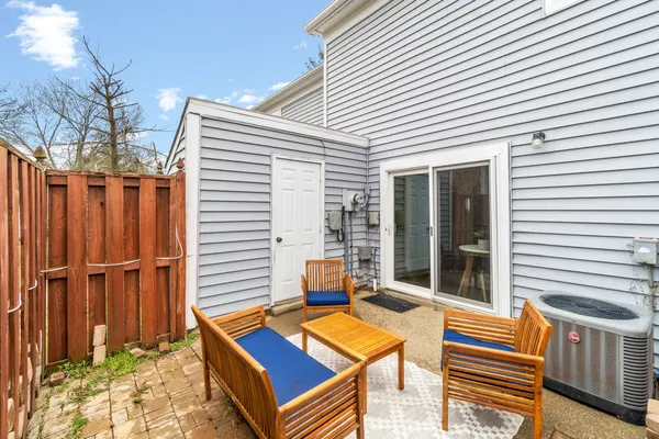 a backyard of a house with barbeque oven table and chairs