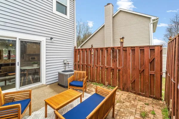 a backyard of a house with barbeque oven table and chairs