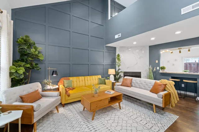 a living room with furniture and a potted plant