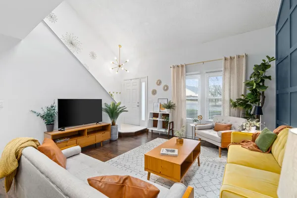 a living room with furniture and a flat screen tv