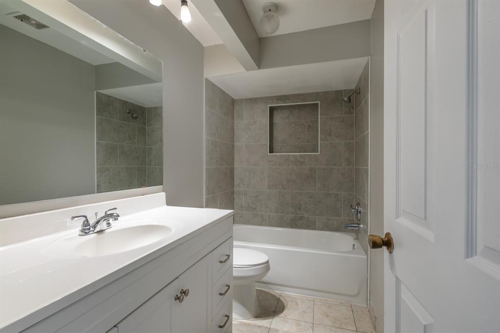 2436 Northland Road Mount Dora, FL 32757 - Photo 13 of 27 a bathroom with a sink a toilet and shower