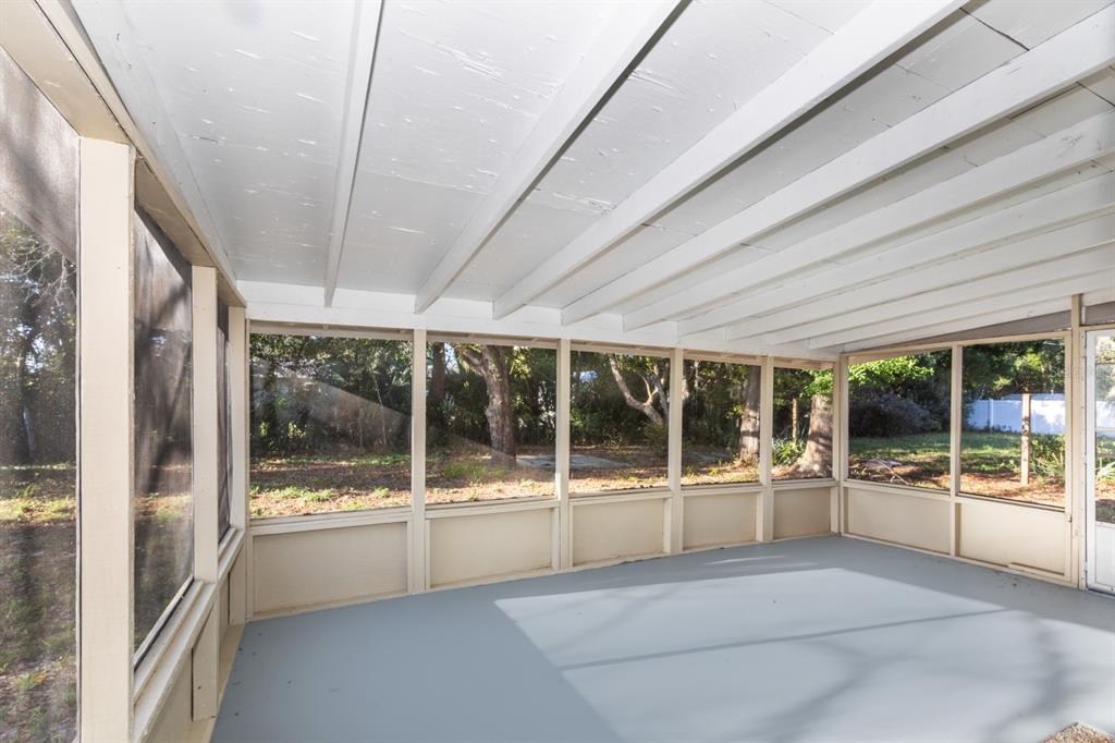 2436 Northland Road Mount Dora, FL 32757 - Photo 15 of 27 a room with large glass window and front door