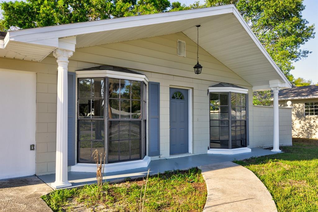 2436 Northland Road Mount Dora, FL 32757 - Photo 2 of 27 a view of white house with a swimming pool