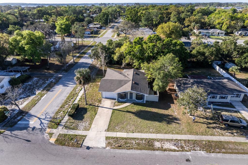 2436 Northland Road Mount Dora, FL 32757 - Photo 22 of 27 an aerial view of a house with a yard and parking