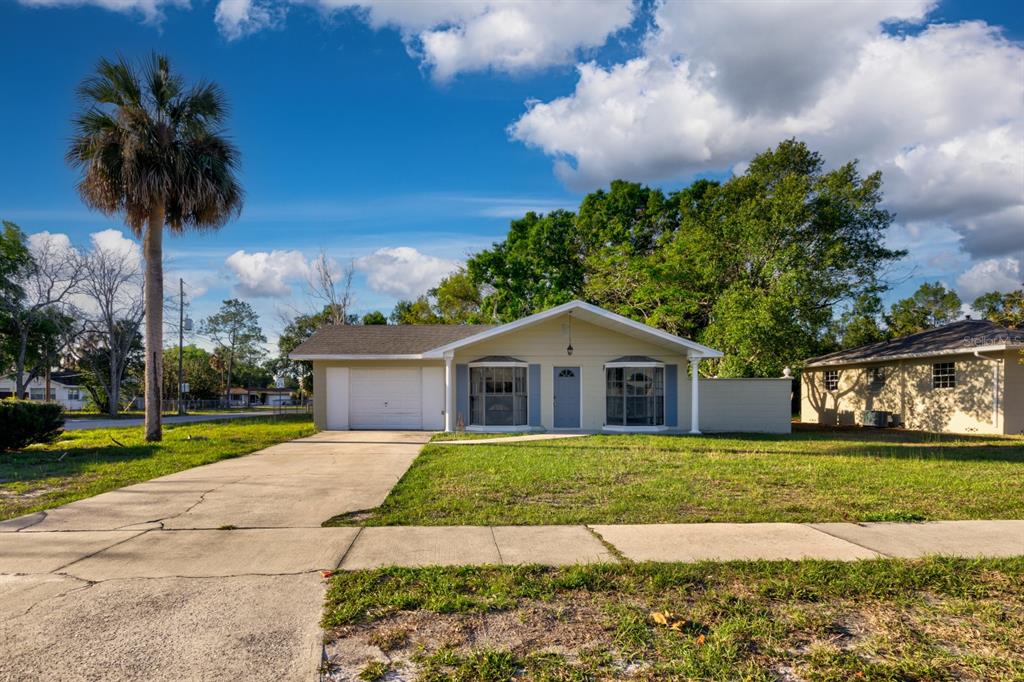 2436 Northland Road Mount Dora, FL 32757 - Photo 27 of 27 a front view of a house with a yard and potted plants