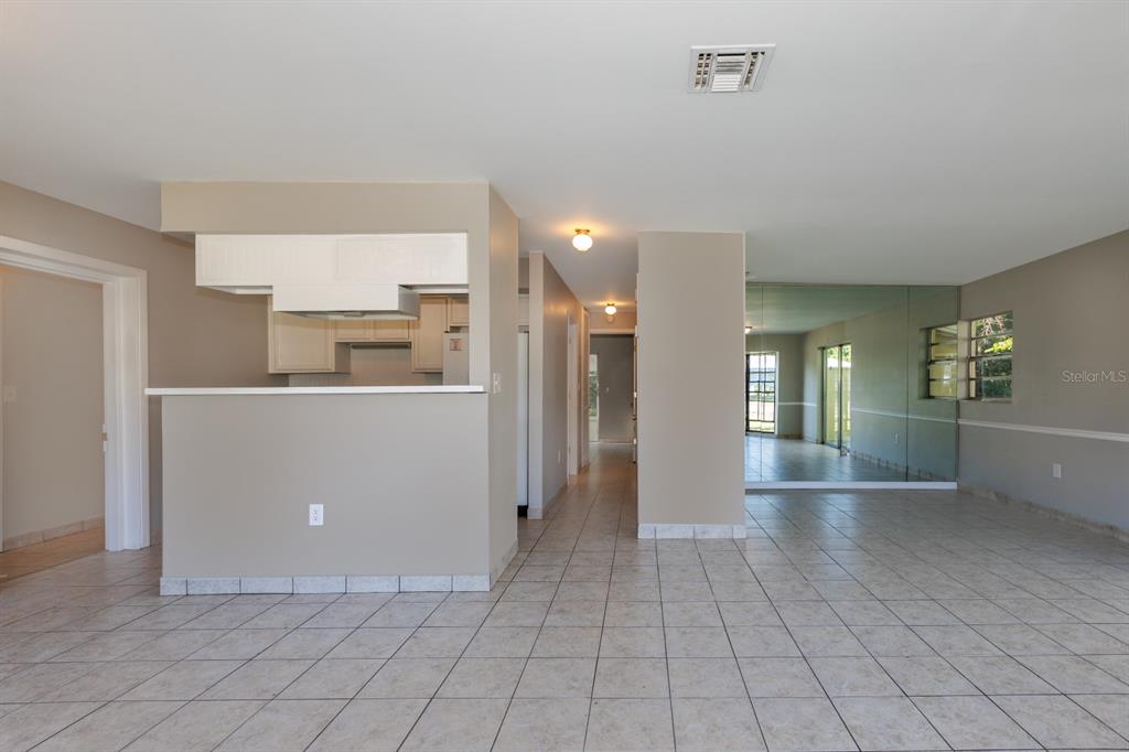 2436 Northland Road Mount Dora, FL 32757 - Photo 3 of 27 a view of a kitchen cabinets and an empty room