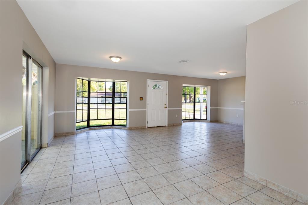 2436 Northland Road Mount Dora, FL 32757 - Photo 4 of 27 wooden floor in an empty room with a window