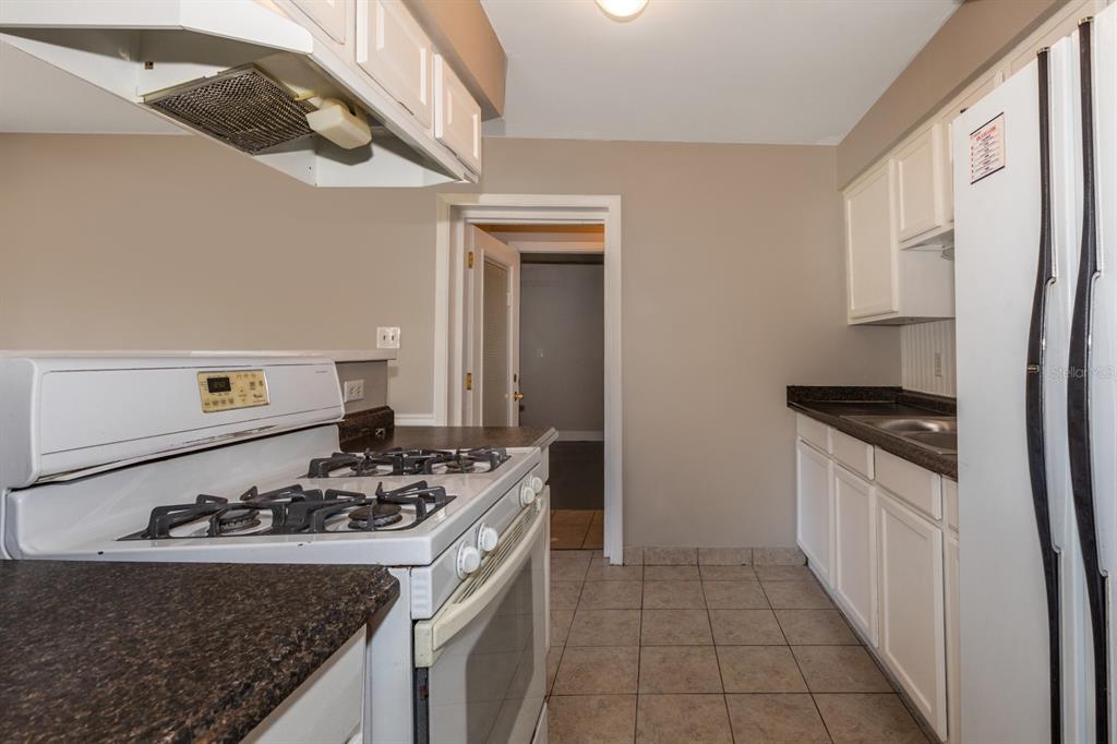 2436 Northland Road Mount Dora, FL 32757 - Photo 7 of 27 a kitchen with a stove and a sink