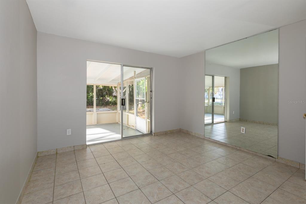 2436 Northland Road Mount Dora, FL 32757 - Photo 8 of 27 a view of an empty room with glass door