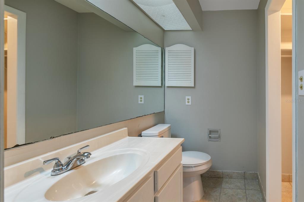 2436 Northland Road Mount Dora, FL 32757 - Photo 10 of 27 a bathroom with a sink toilet and mirror