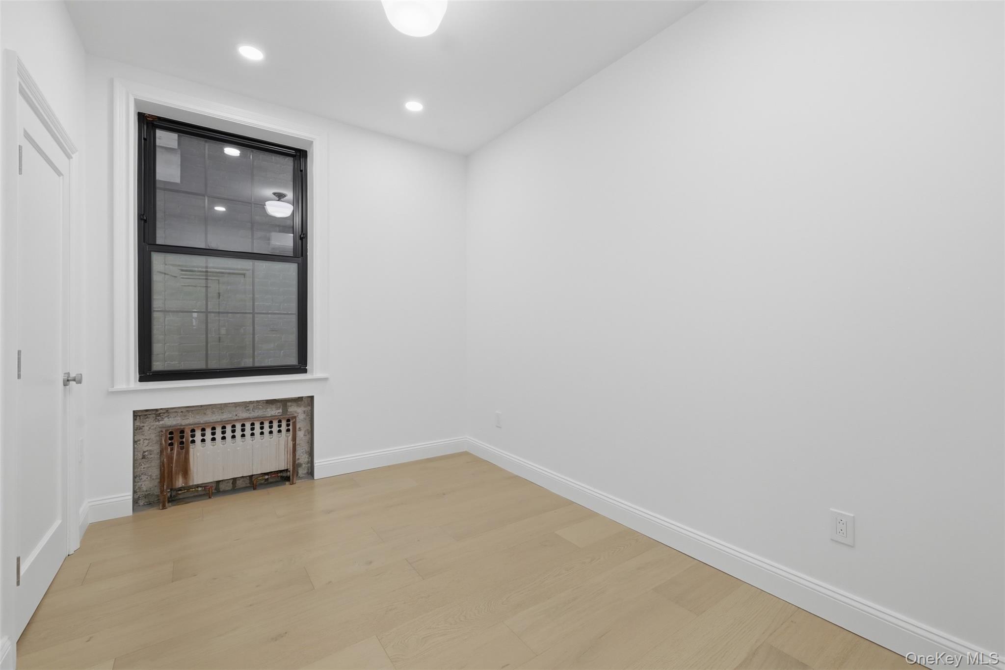 201 Main Street, Unit 2 Beacon, NY 12508 - Photo 8 of 24 Bedroom 2 with Private Mini-split and original cast iron radiator with heat included + closet