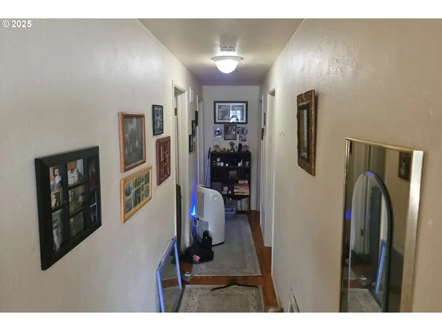 a view of a hallway with workspace and closet
