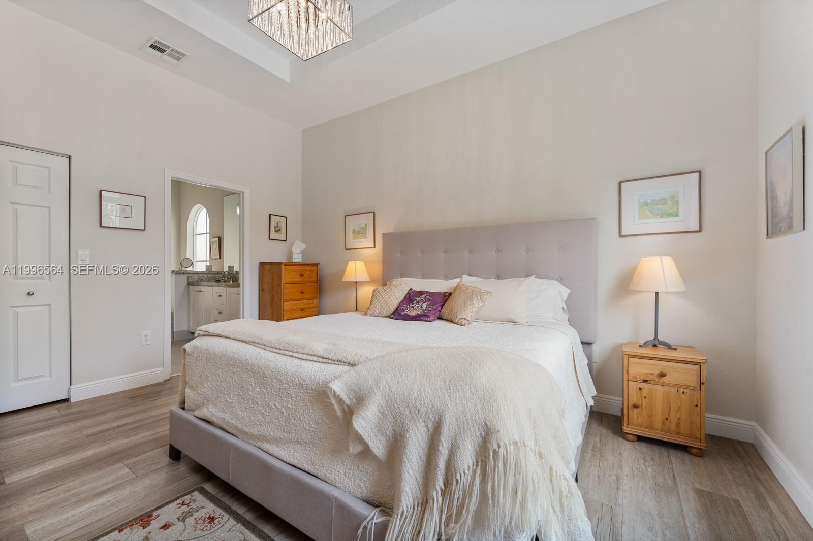 9473 Southwest 227th Terrace Cutler Bay, FL 33190 - Photo 12 of 31 a bedroom with a bed and wooden floor