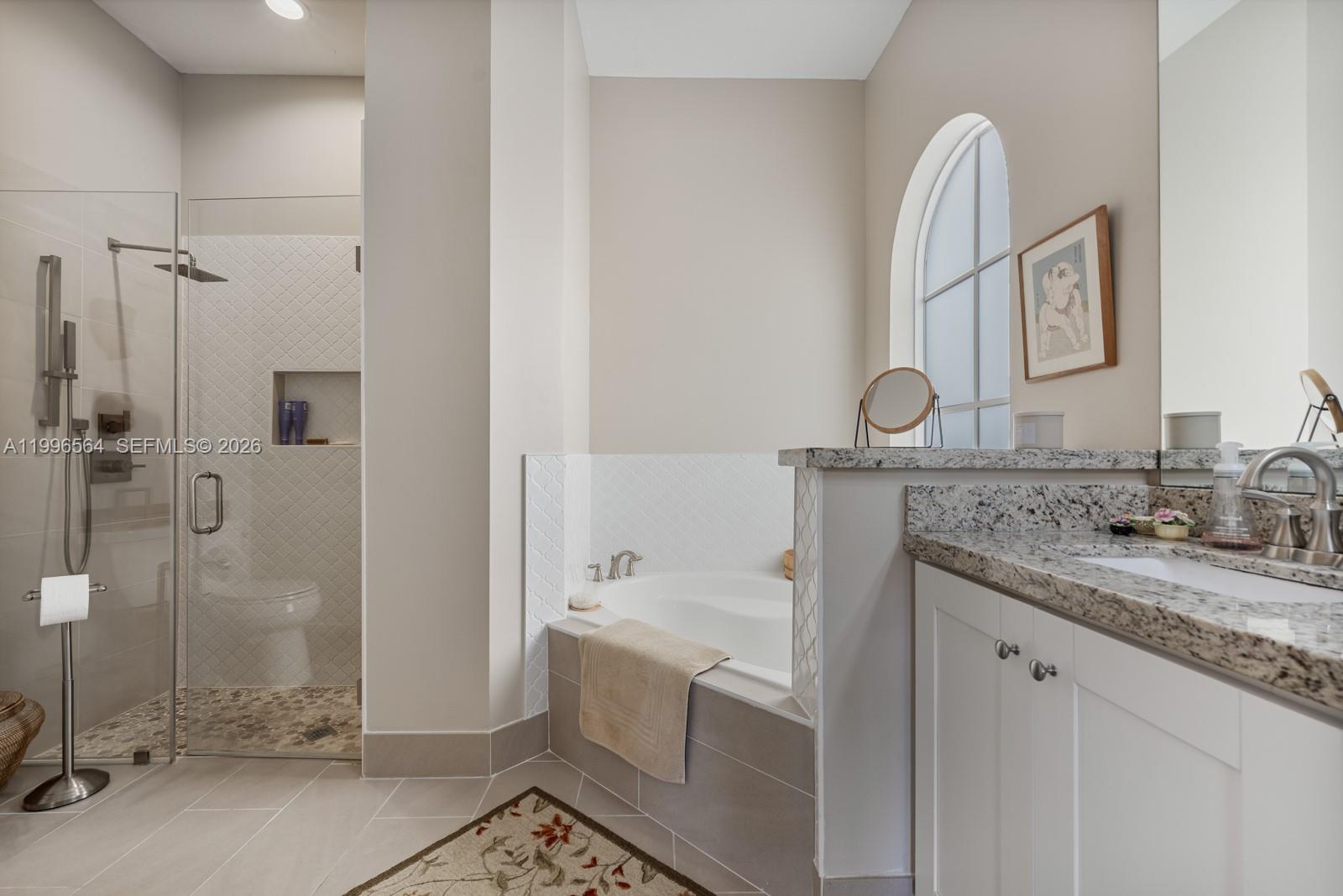 9473 Southwest 227th Terrace Cutler Bay, FL 33190 - Photo 14 of 31 a bathroom with a granite countertop sink mirror and shower