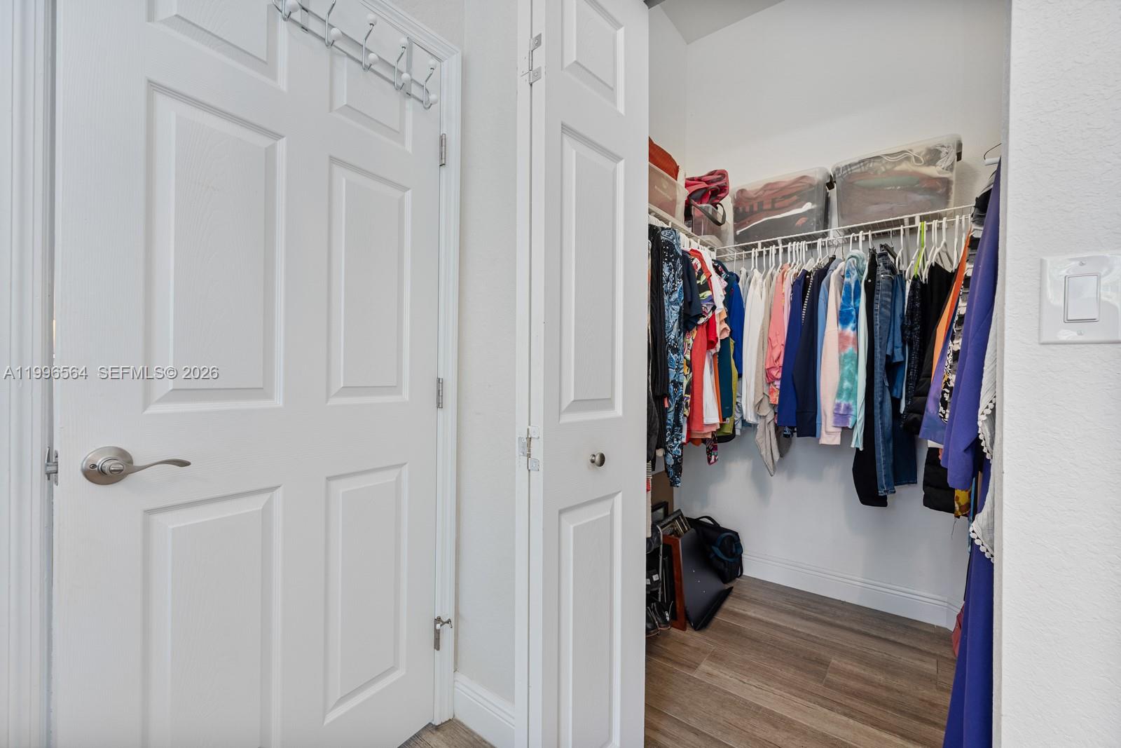 9473 Southwest 227th Terrace Cutler Bay, FL 33190 - Photo 15 of 31 a view of walk in closet with clothes