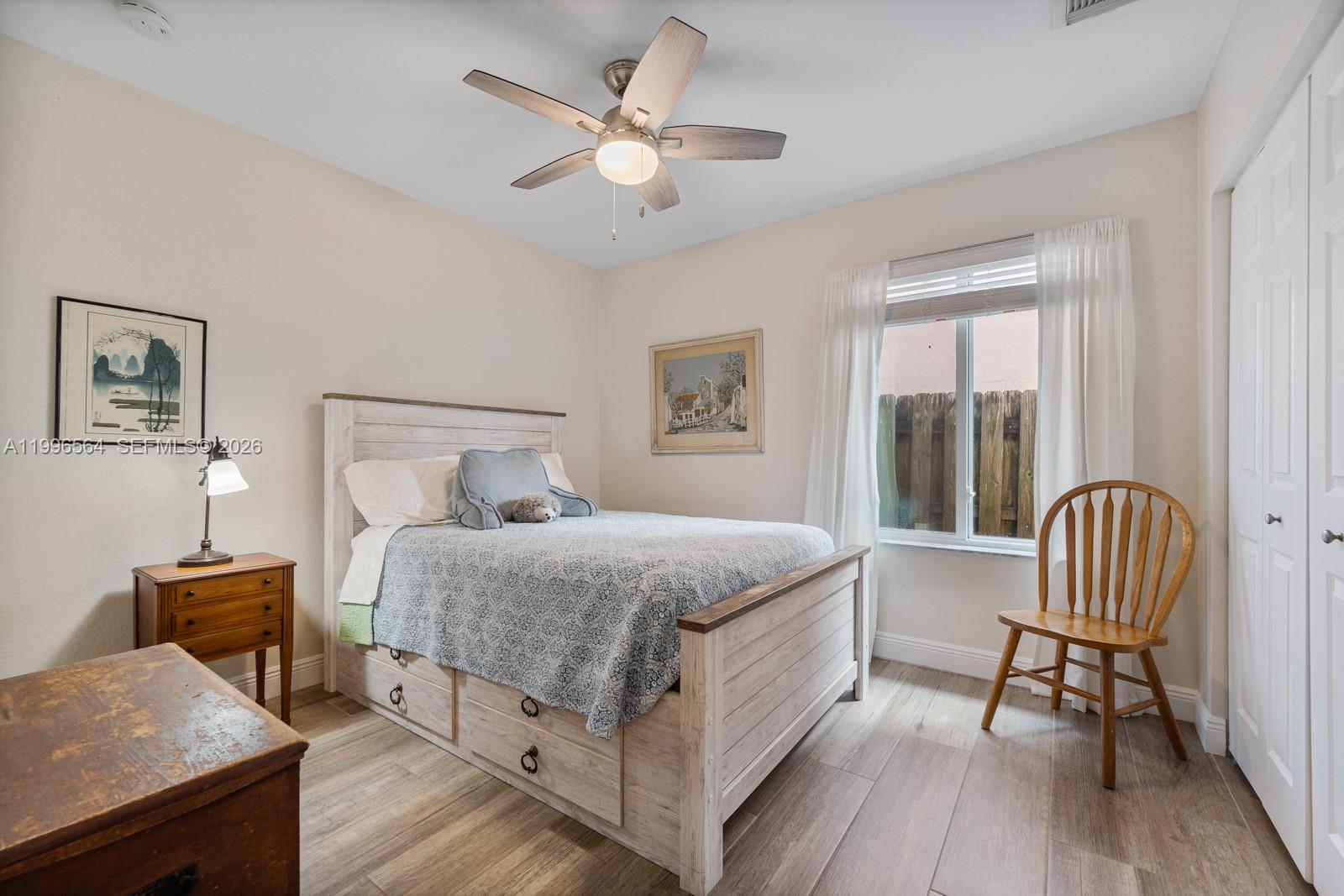 9473 Southwest 227th Terrace Cutler Bay, FL 33190 - Photo 16 of 31 a bedroom with a bed and a chandelier