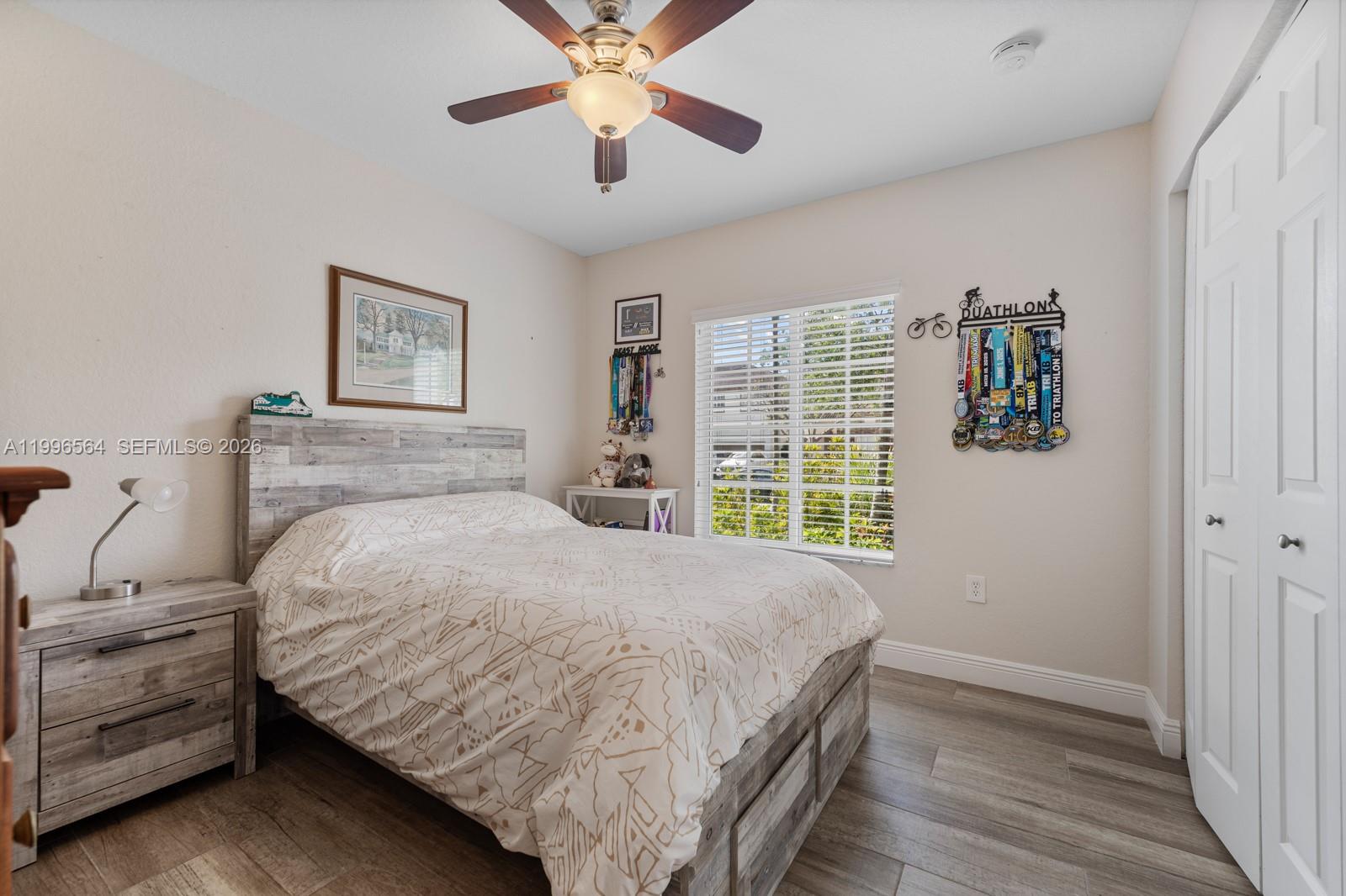 9473 Southwest 227th Terrace Cutler Bay, FL 33190 - Photo 17 of 31 a bedroom with a large bed and a chandelier