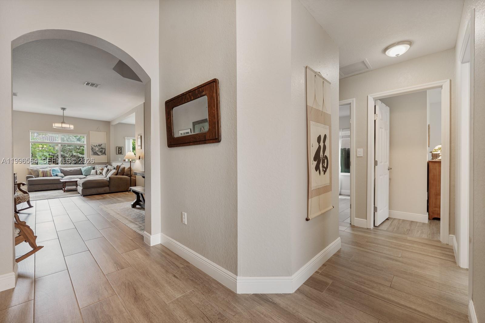 9473 Southwest 227th Terrace Cutler Bay, FL 33190 - Photo 2 of 31 a view of a livingroom with furniture a ceiling fan and wooden floor