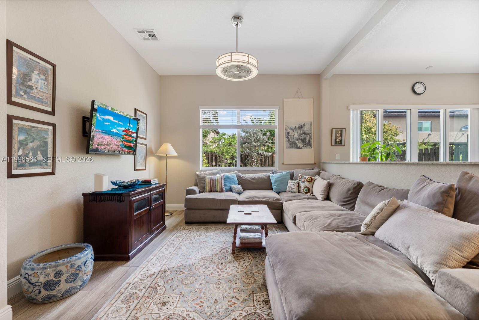 9473 Southwest 227th Terrace Cutler Bay, FL 33190 - Photo 5 of 31 a living room with furniture a chandelier and a window