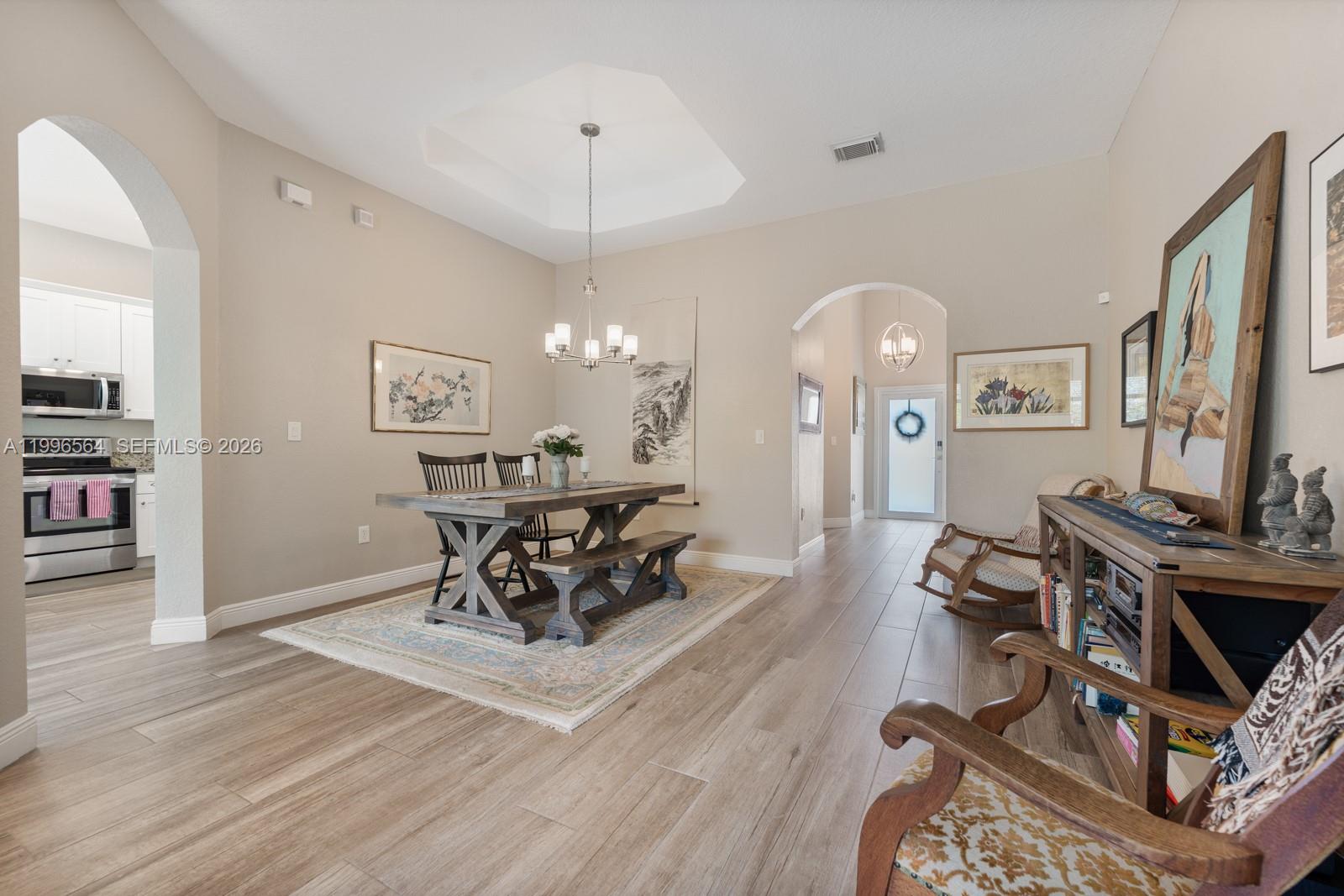 9473 Southwest 227th Terrace Cutler Bay, FL 33190 - Photo 6 of 31 a living room with furniture a piano and a flat screen tv