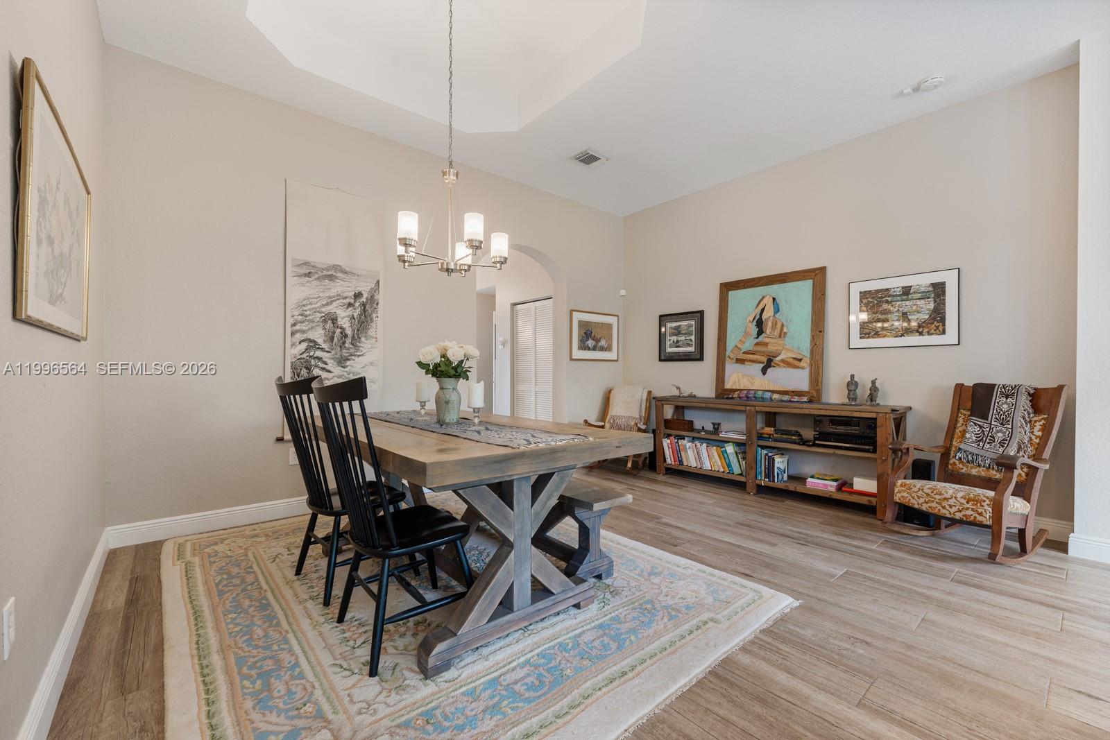 9473 Southwest 227th Terrace Cutler Bay, FL 33190 - Photo 7 of 31 a view of a dining room with furniture and wooden floor