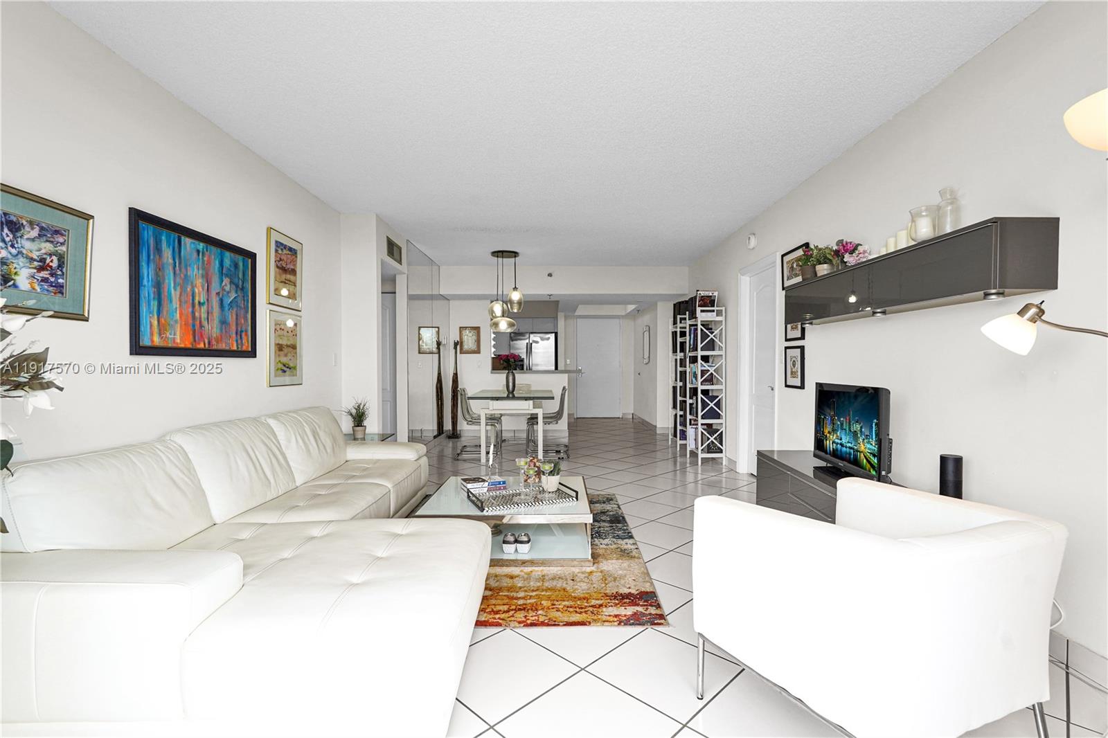 9455 Collins Avenue, Unit 603 Surfside, FL 33154 - Photo 8 of 22 a living room with furniture and a fireplace