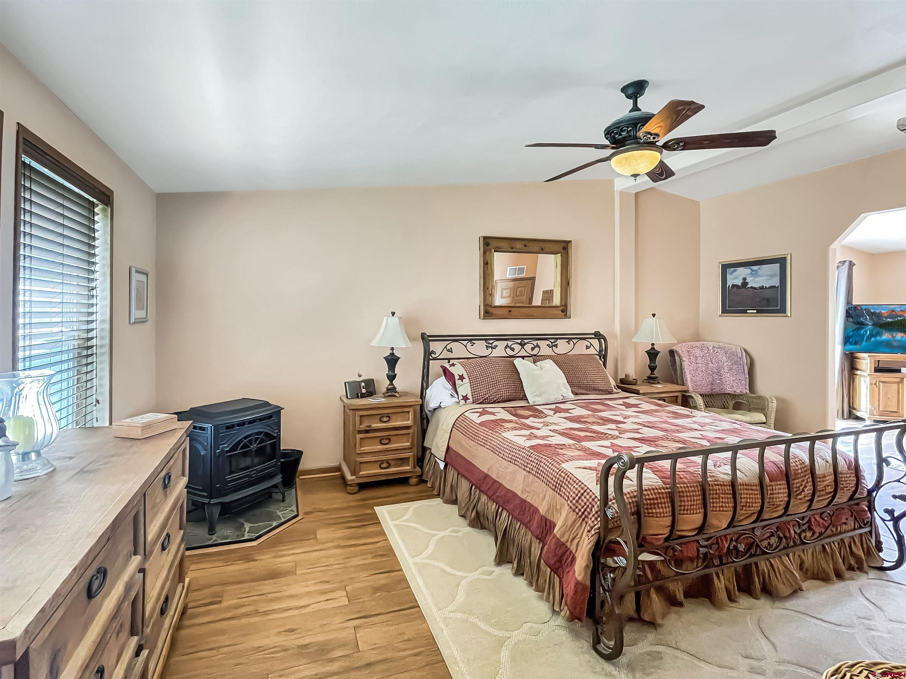 43396 Long Gulch Road Crawford, CO 81415 - Photo 13 of 35 a bedroom with a bed and a chandelier