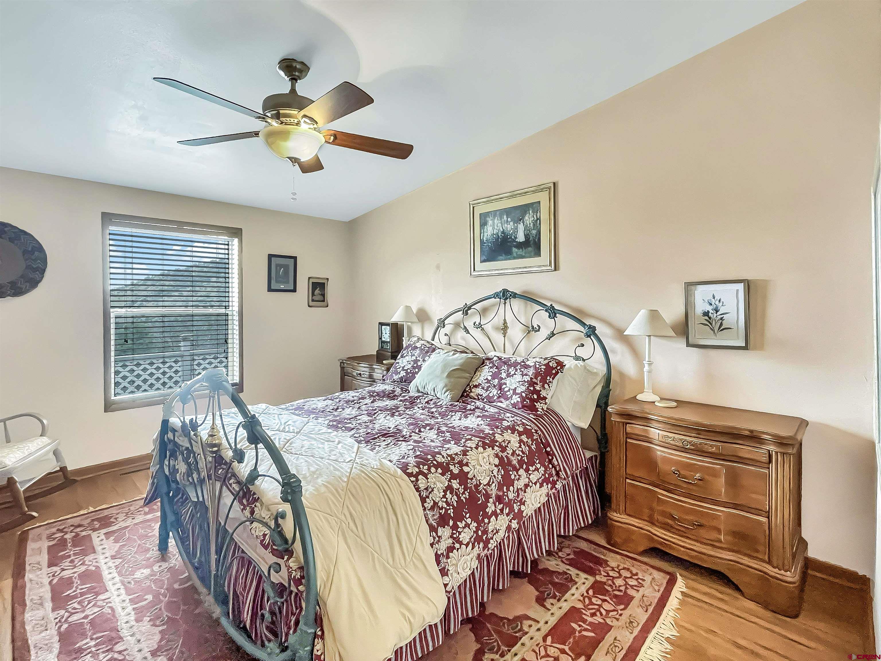 43396 Long Gulch Road Crawford, CO 81415 - Photo 23 of 35 a bedroom with a bed and a chandelier