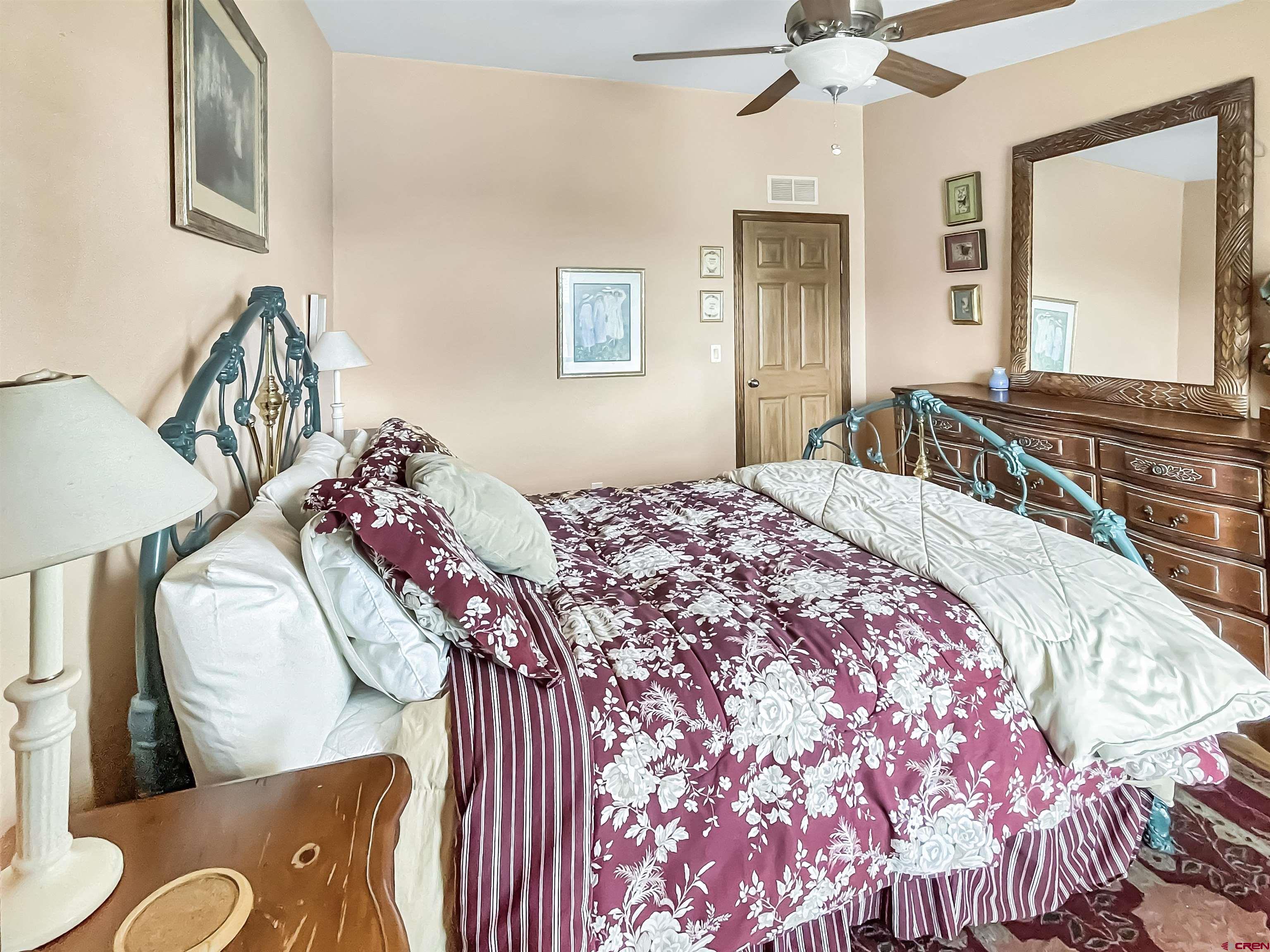 43396 Long Gulch Road Crawford, CO 81415 - Photo 24 of 35 a bedroom with a bed and dresser with mirror