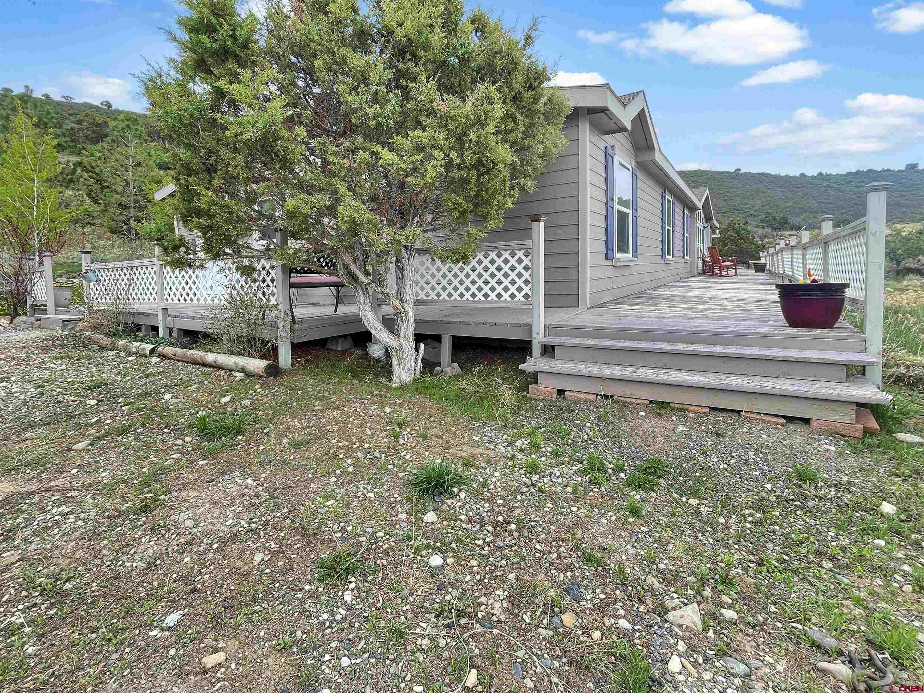 43396 Long Gulch Road Crawford, CO 81415 - Photo 28 of 35 a view of a house with a yard and deck