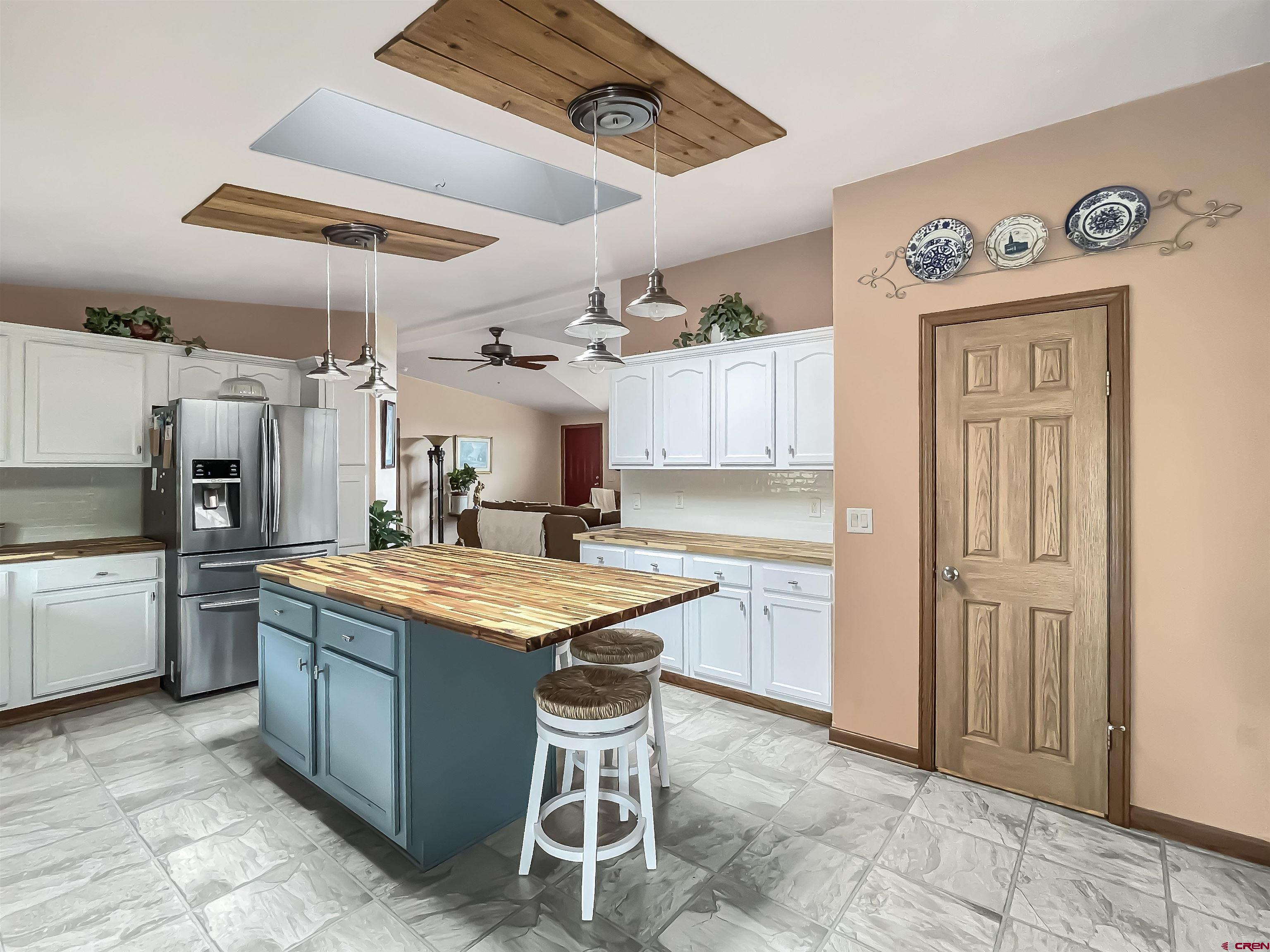 43396 Long Gulch Road Crawford, CO 81415 - Photo 8 of 35 a kitchen with a sink a stove and chairs