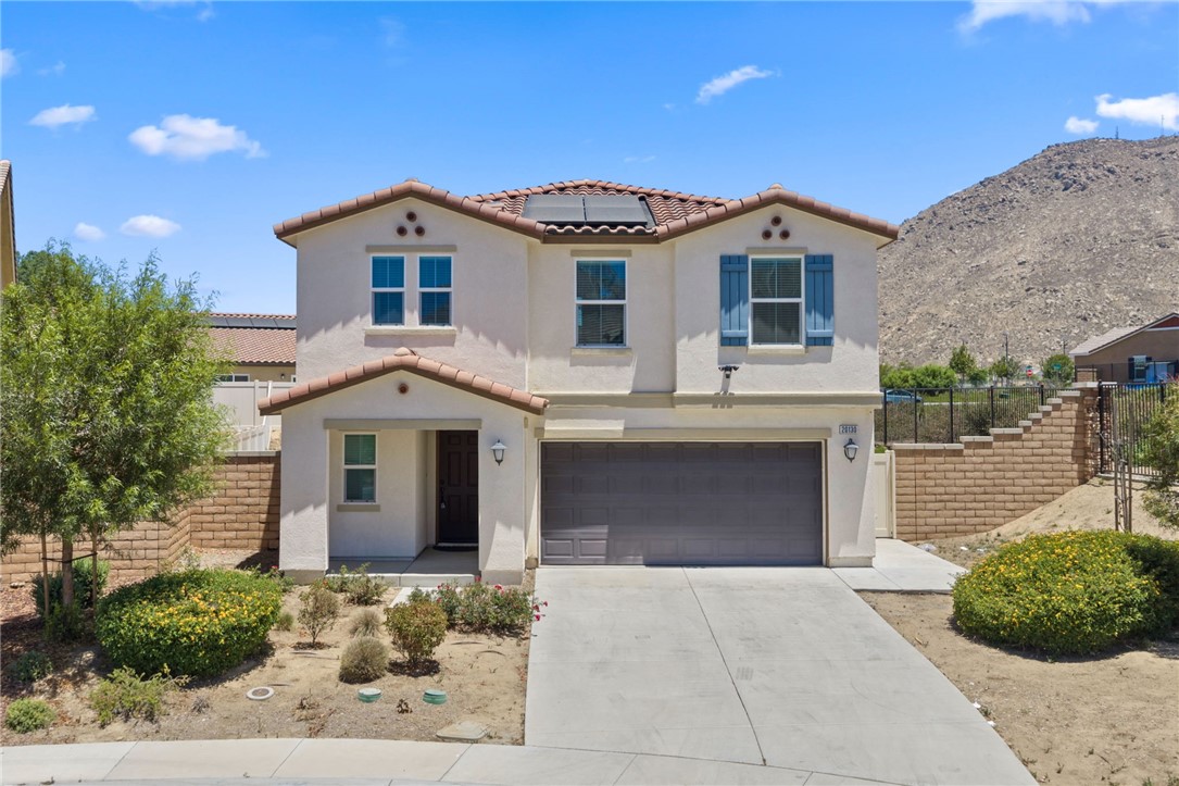 20130 Curaco Court Riverside, CA 92507 - Photo 3 of 43 Daytime front view featuring tile roofing, solar panels, and an attached garage.