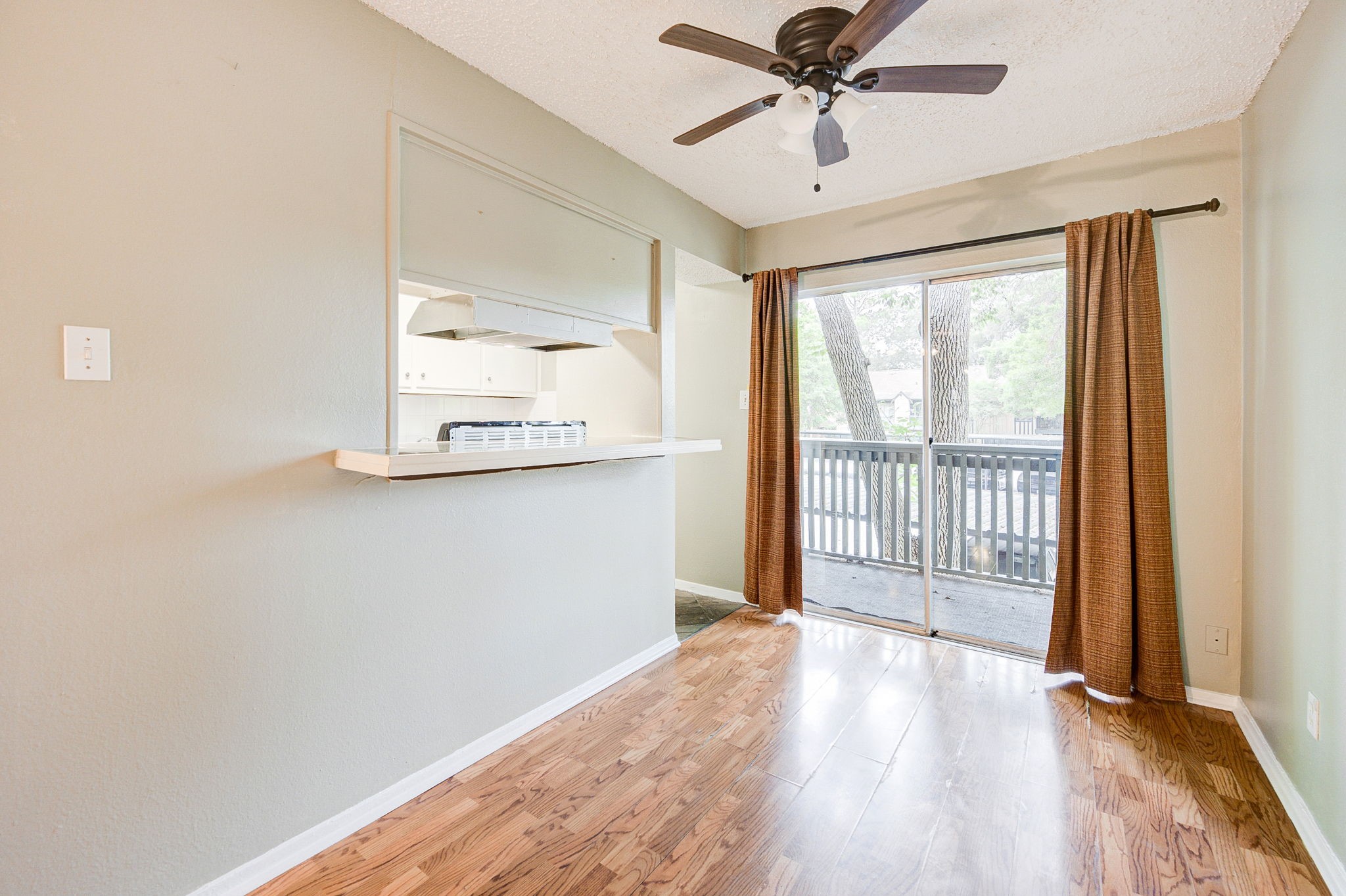 8229 Kingsbrook Road, Unit 229 Houston, TX 77024 - Photo 14 of 50 a view of a livingroom with wooden floor and a ceiling fan