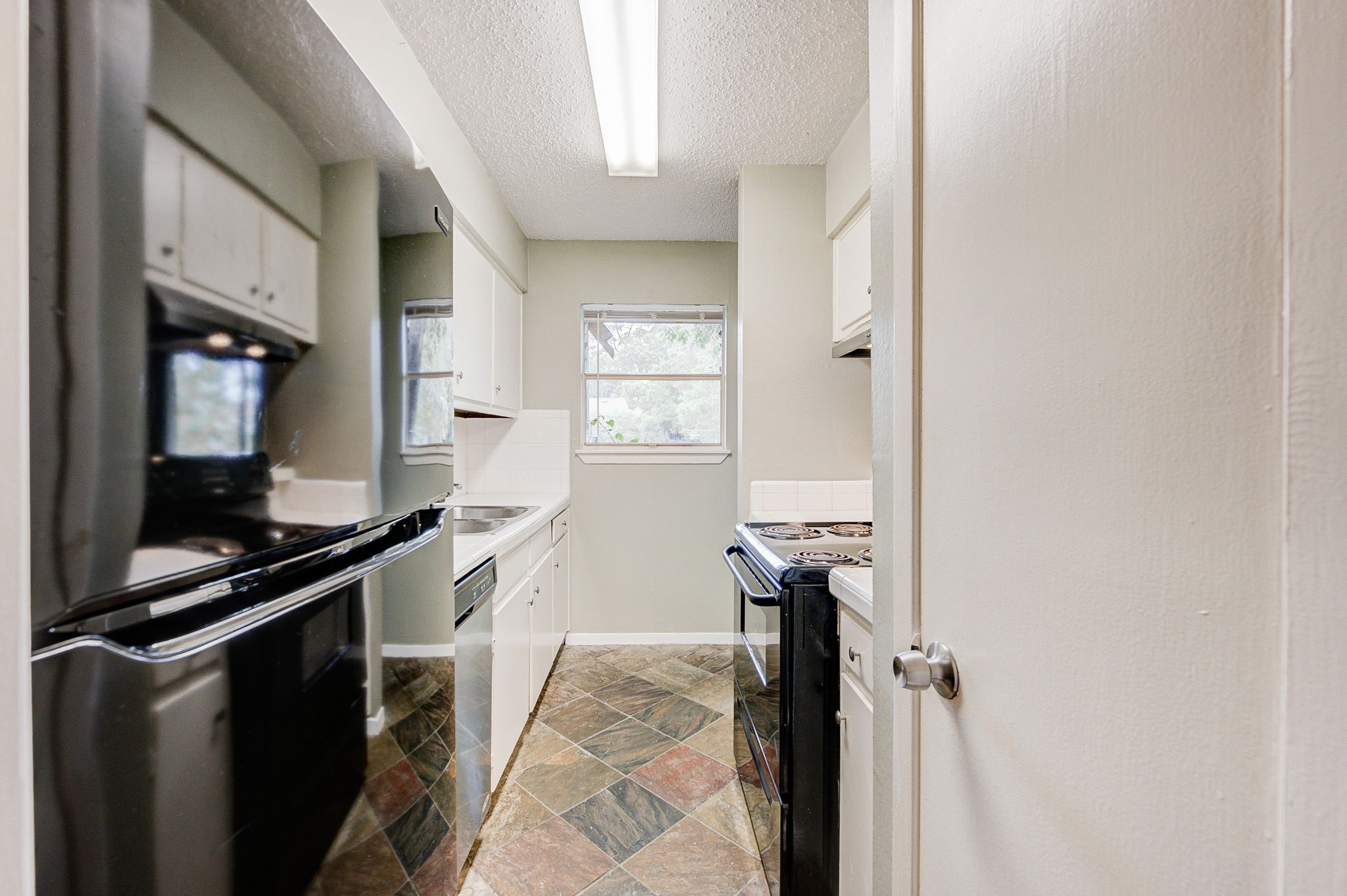 8229 Kingsbrook Road, Unit 229 Houston, TX 77024 - Photo 19 of 50 a kitchen with a sink appliances and a window