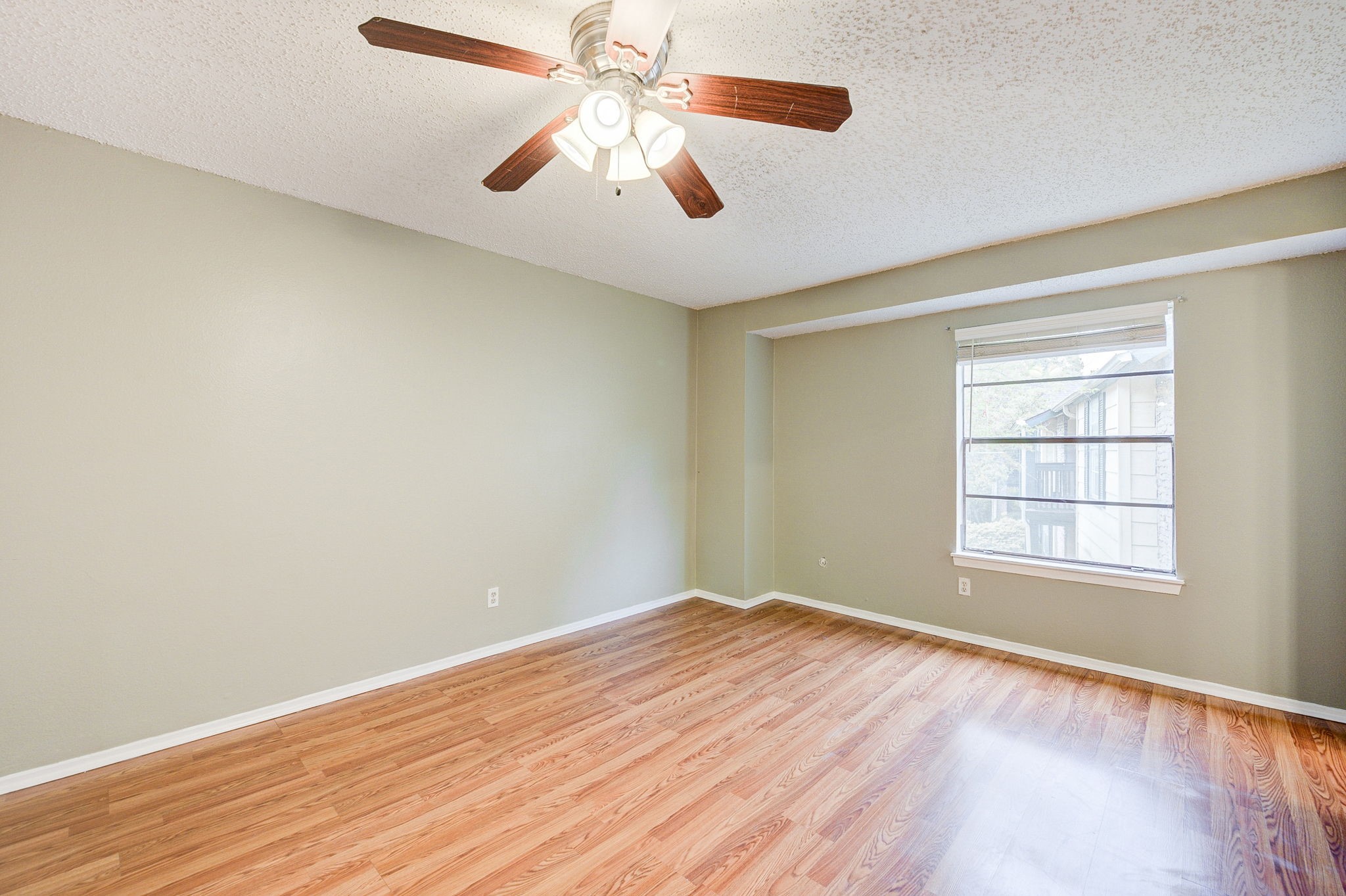 8229 Kingsbrook Road, Unit 229 Houston, TX 77024 - Photo 23 of 50 an empty room with wooden floor fan and windows