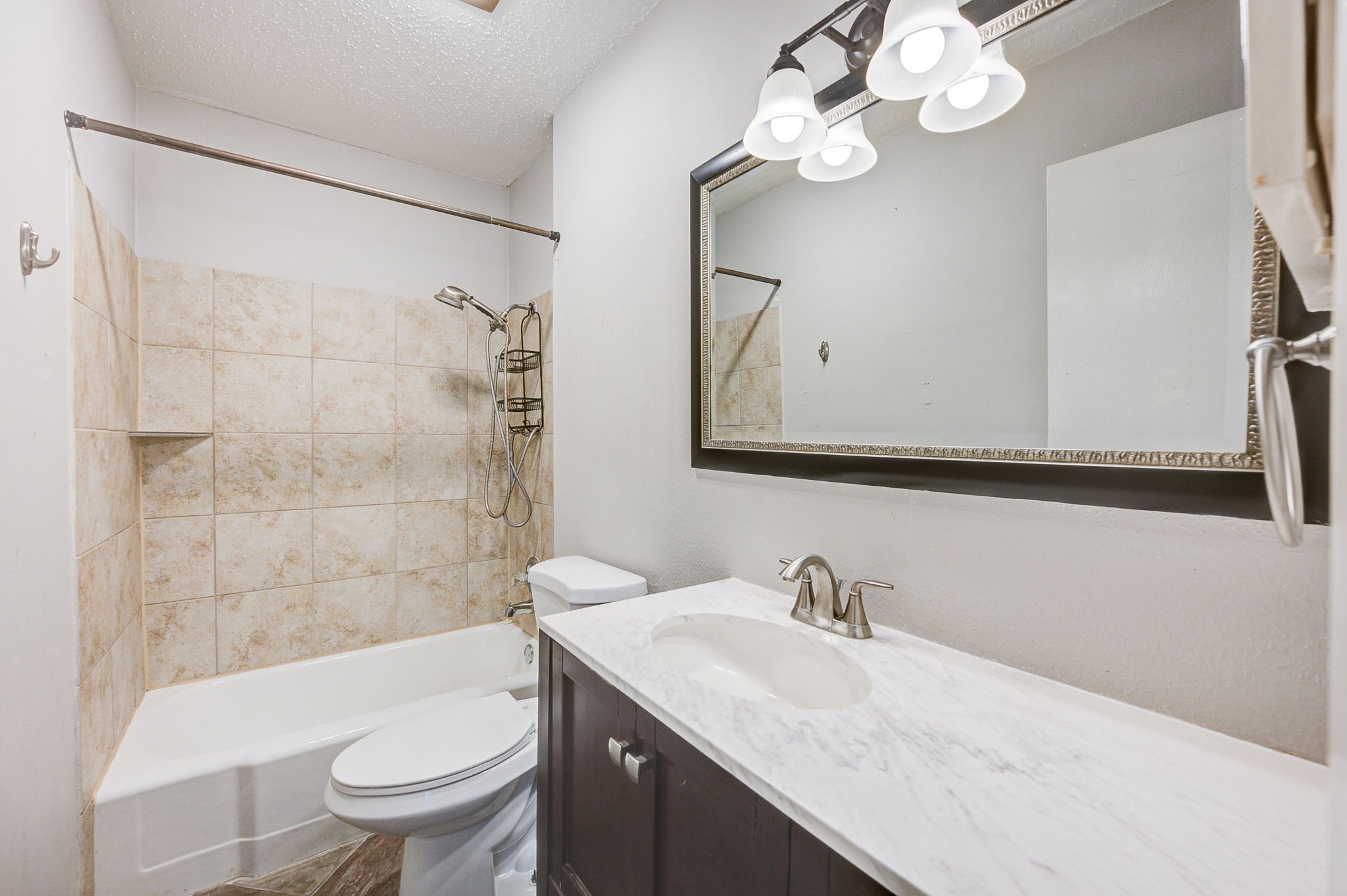 8229 Kingsbrook Road, Unit 229 Houston, TX 77024 - Photo 26 of 50 a bathroom with a granite countertop sink a toilet and a mirror