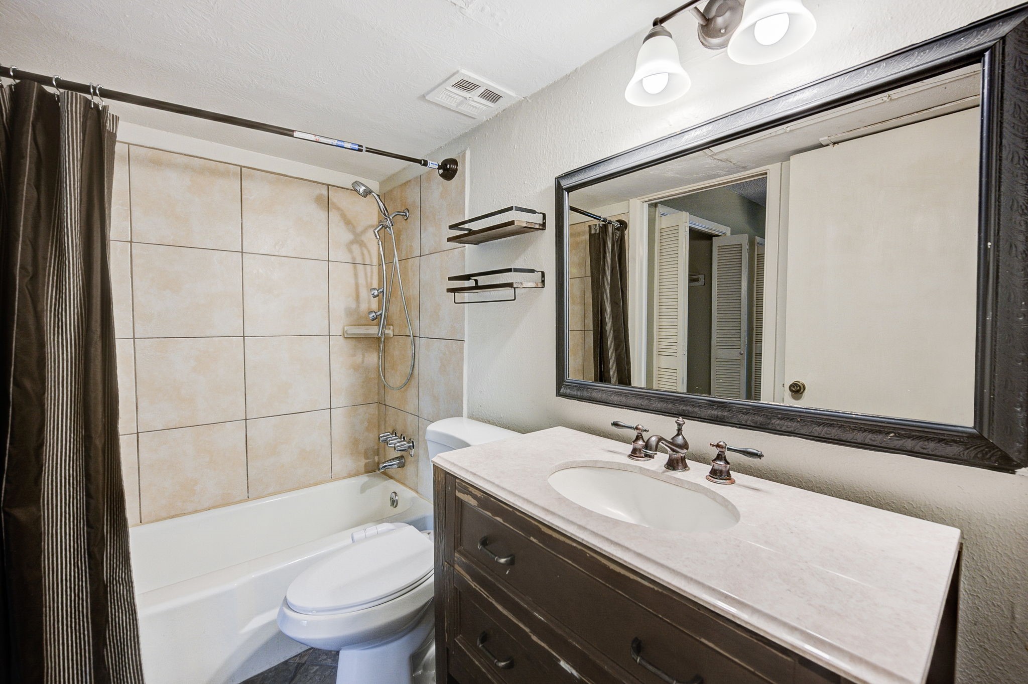 8229 Kingsbrook Road, Unit 229 Houston, TX 77024 - Photo 27 of 50 a bathroom with a sink toilet vanity and shower