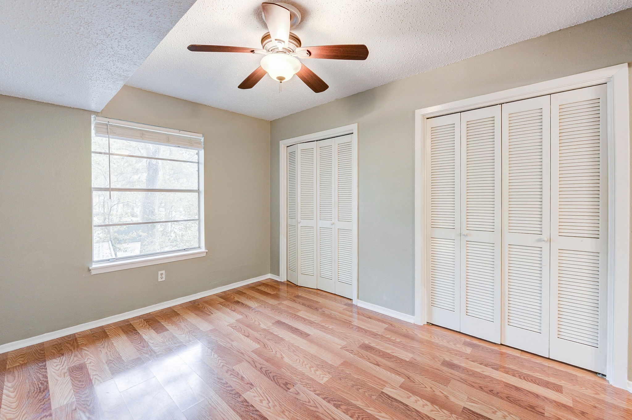 8229 Kingsbrook Road, Unit 229 Houston, TX 77024 - Photo 30 of 50 a view of an empty room with a window and wooden floor