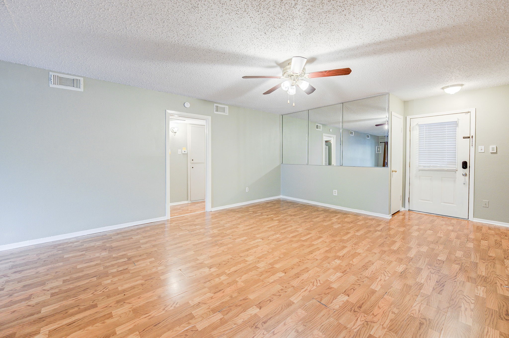 8229 Kingsbrook Road, Unit 229 Houston, TX 77024 - Photo 9 of 50 wooden floor in an empty room with a window
