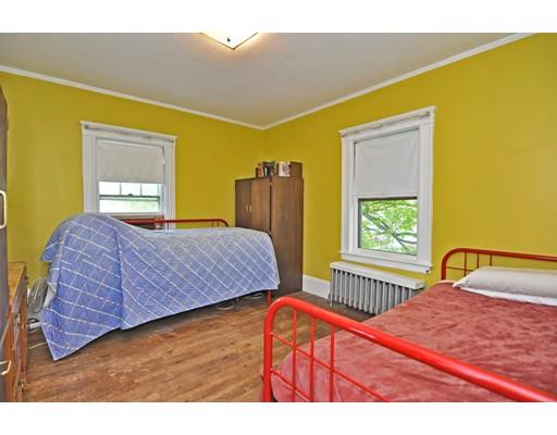 196 Chiswick Road Boston, MA 02135 - Photo 17 of 23 a bedroom with a bed and wooden floor