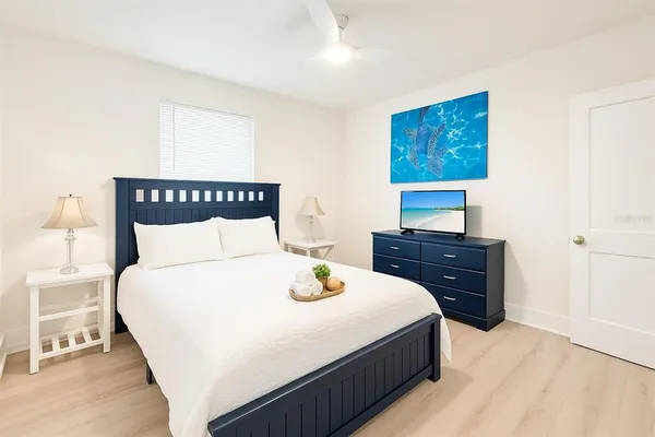 a bedroom with a bed and a night stand