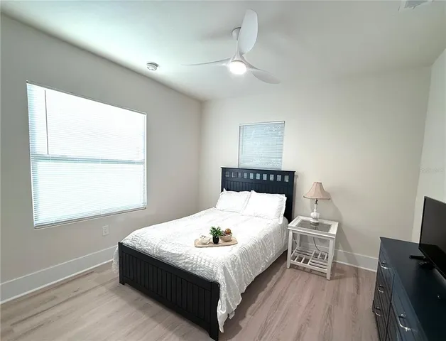 a bed sitting in a bedroom next to a window