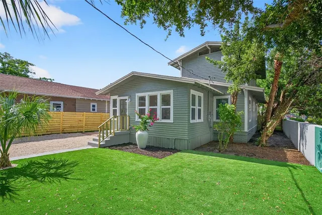 a front view of house with yard and outdoor seating
