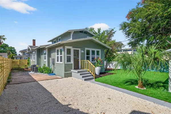 a front view of a house with a yard and porch