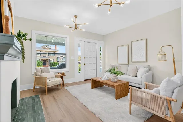 a living room with furniture and a chandelier