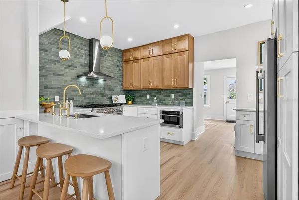 a kitchen with sink refrigerator and cabinets